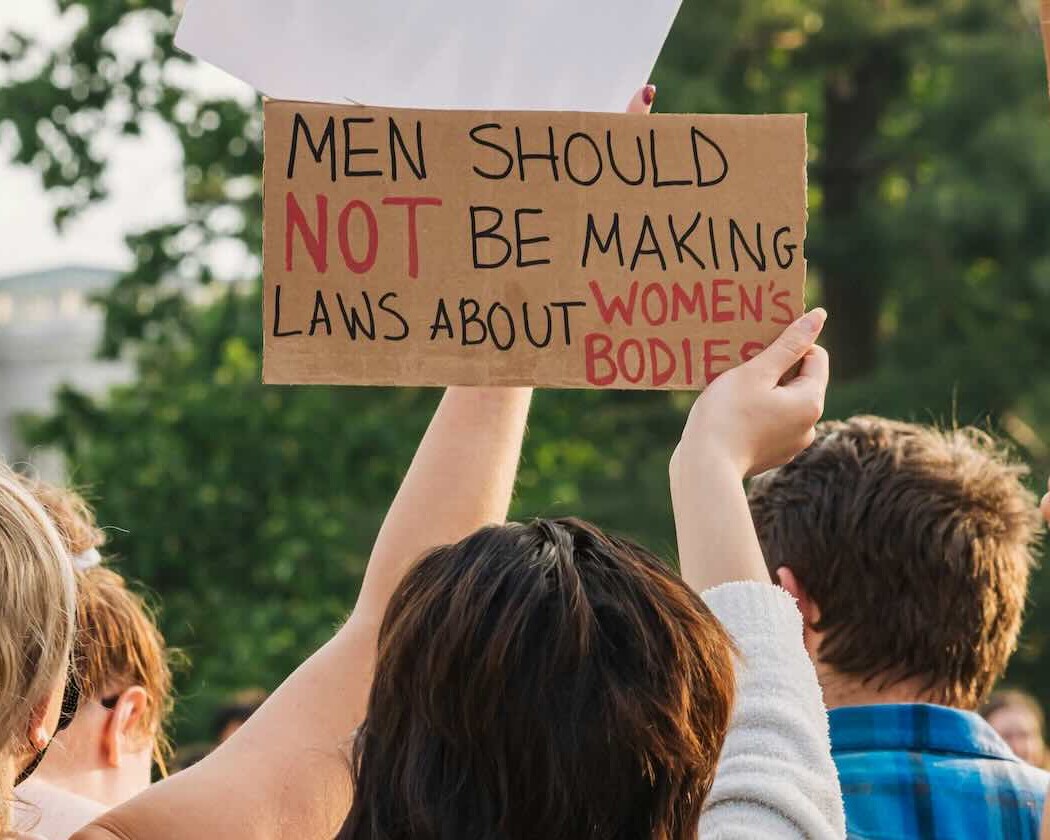 Woman holding a sign about bodily autonomy