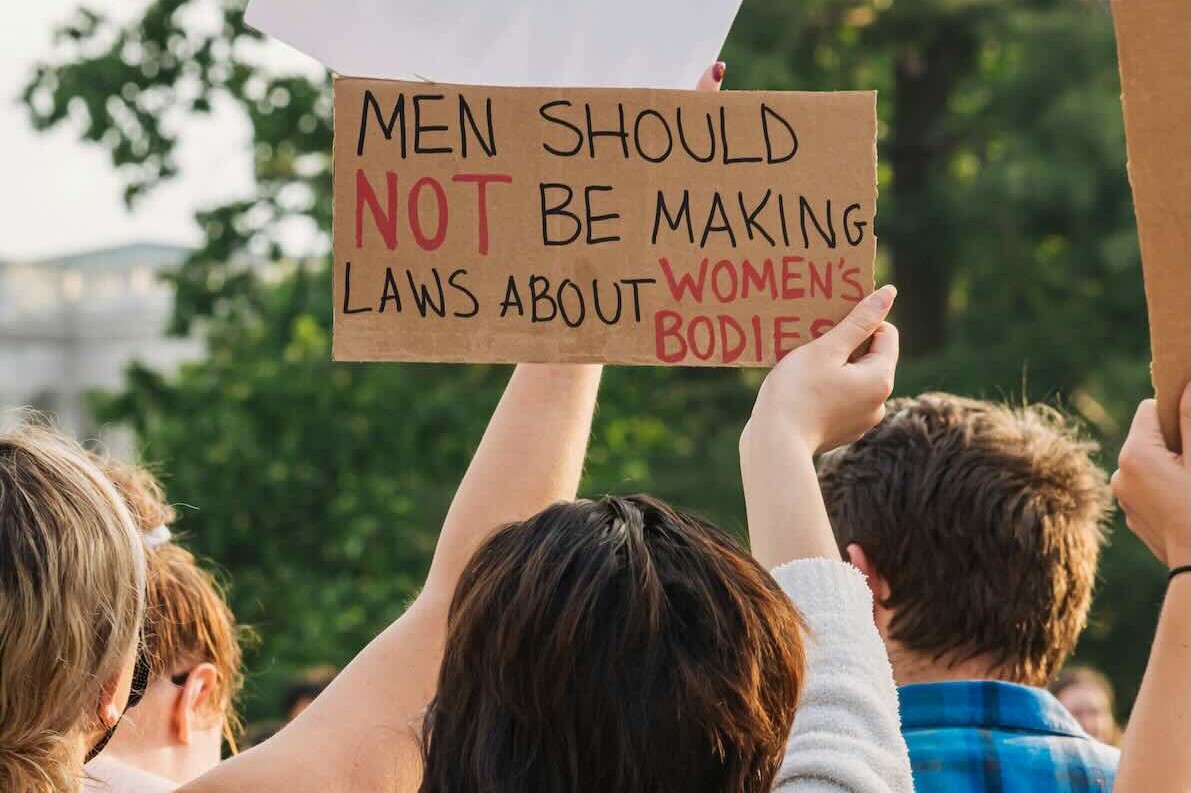 Woman holding a sign about bodily autonomy