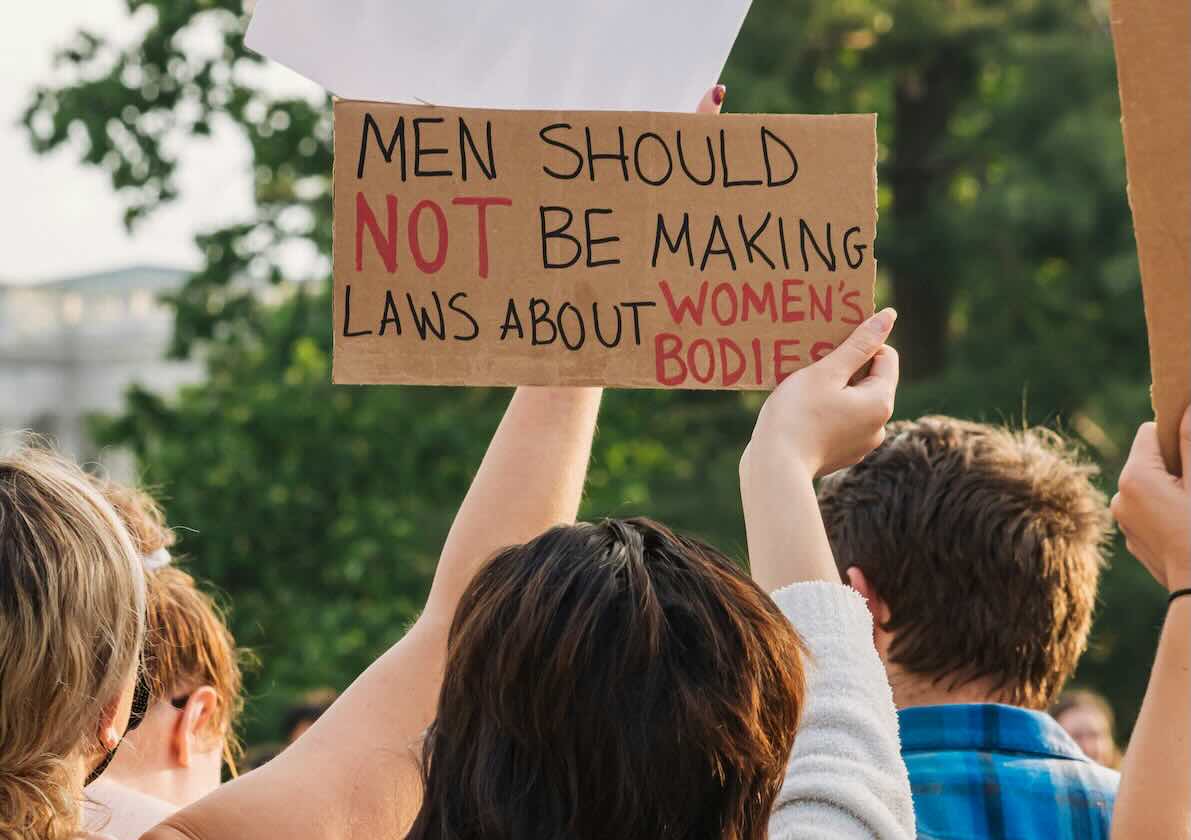 Woman holding a sign about bodily autonomy