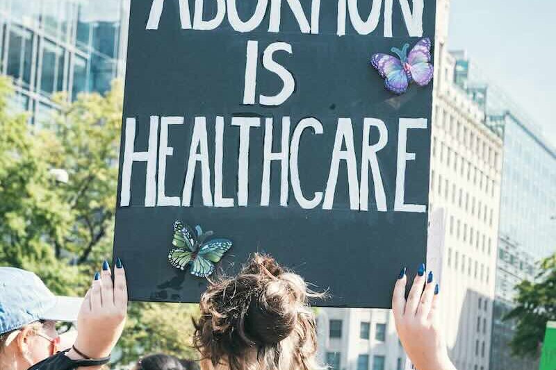Woman holding Abortion is Healthcare sign