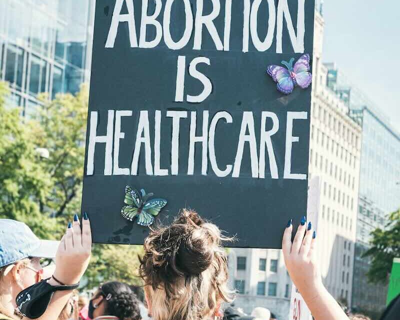 Woman holding Abortion is Healthcare sign